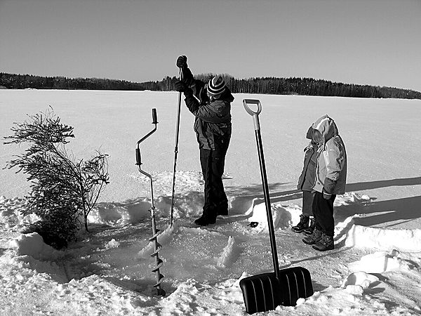 Drilling a hole to measure lake ice thickness